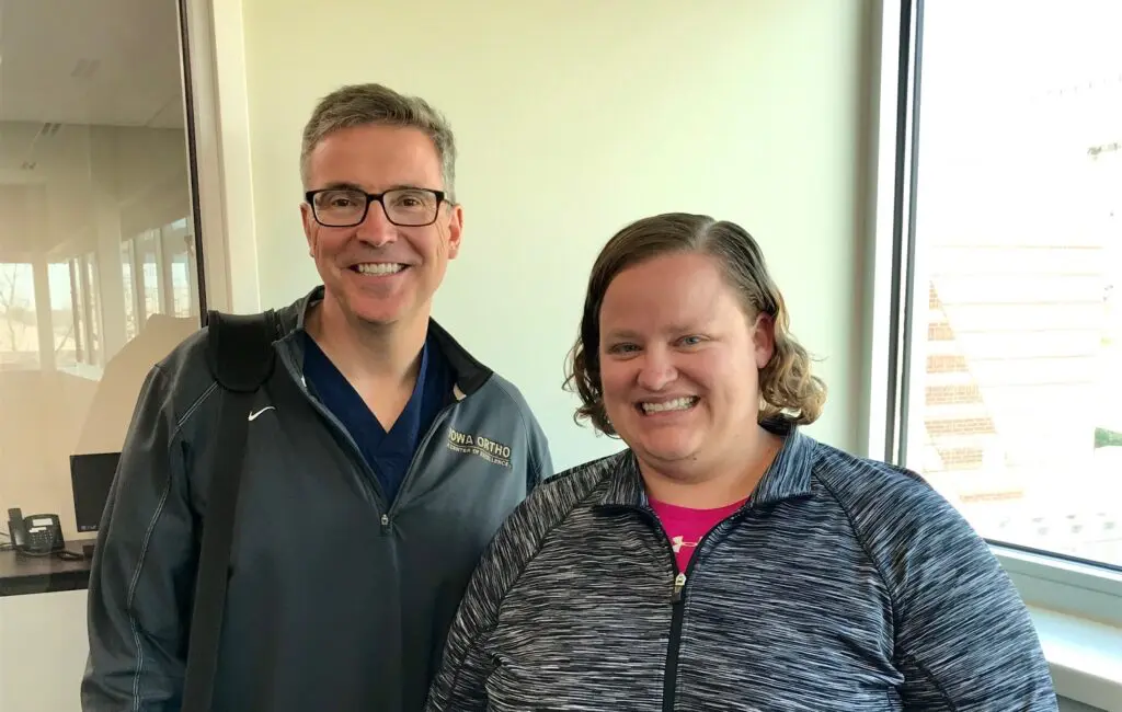 Dr. Mahoney stands next to patient Kendsey