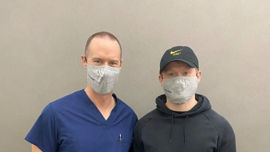Dr. Vinyard stands next to patient Zach