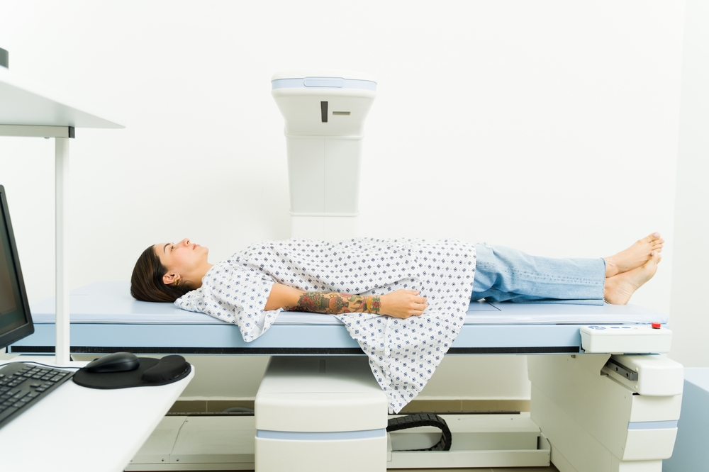 Patient undergoing a DXA scan to measure bone density for osteoporosis risk assessment