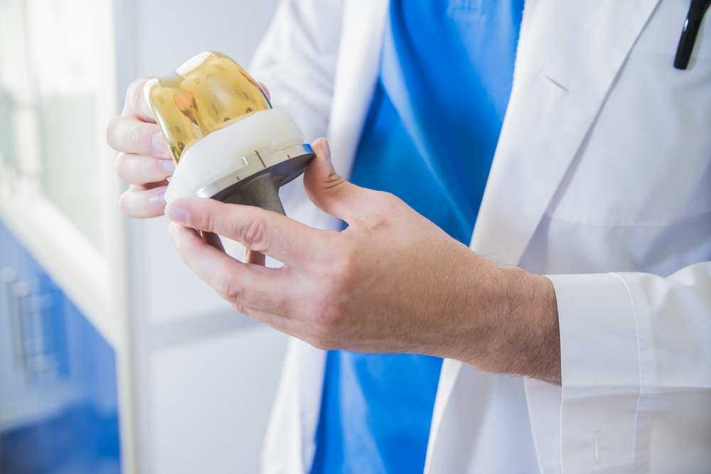 Doctor explaining joint replacement options to a patient with chronic knee pain