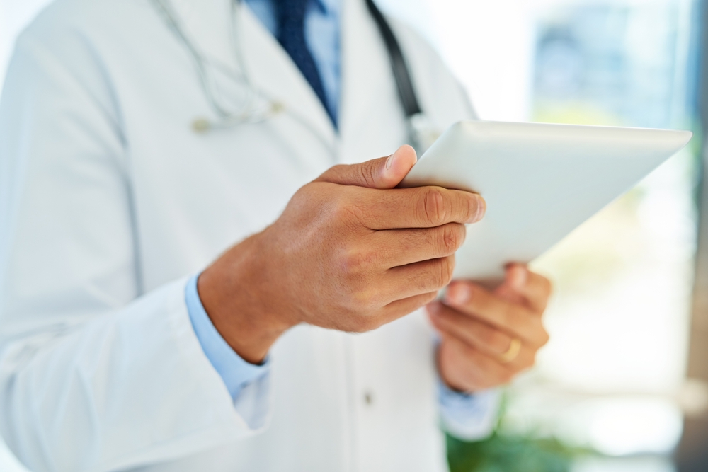 Orthopedic specialist reviewing patient records for a second opinion consultation