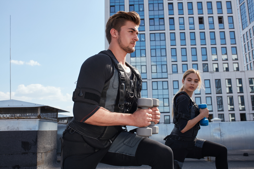 People exercising outdoors wearing a weighted vest, demonstrating strength and calorie-burning benefits while staying mindful of joint health.